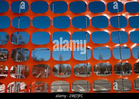 high visibility net, work in progress on a construction site, fence of a construction site with high visibility orange colored elements. safety Stock Photo