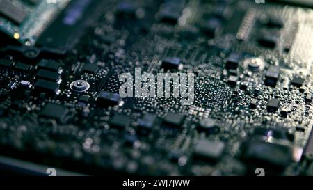 Close Up Of Electronic Circuit Board Of Laptop Being Repaired In Workshop With Low Key Lighting Stock Photo