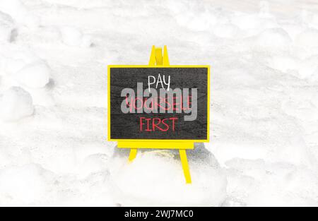 Pay yourself first symbol. Concept words Pay yourself first on beautiful black chalk blackboard. Beautiful white snow background. Business and pay you Stock Photo