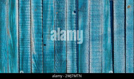 Texture of old blue wooden fence. Rustic wooden boards for background. Stock Photo