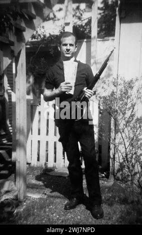 Lee Harvey Oswald. Portrait of the assassin of John F Kennedy, Lee Harvey Oswald (1939-1963), taken in Oswald's back yard, Neely Street, Dallas, Texas, March 1963. Stock Photo