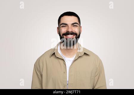 Smiling handsome young latin guy with a beard in casual looking at camera Stock Photo