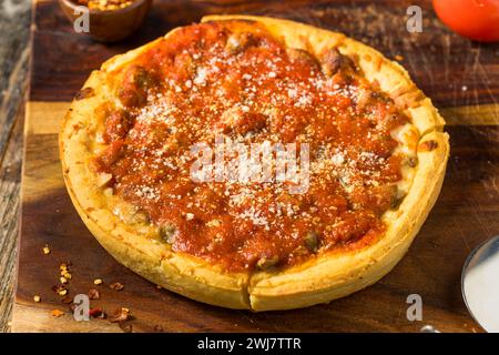 Homemade Mini Chicago Style Deep Dish Pizza with Sausage Stock Photo