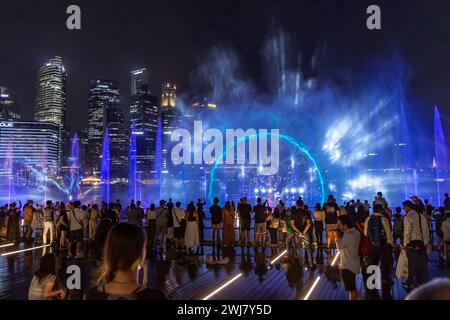 Free-to-public outdoor Light and Water Show along promenade in front of Marina Bay Sands, Singapore Stock Photo