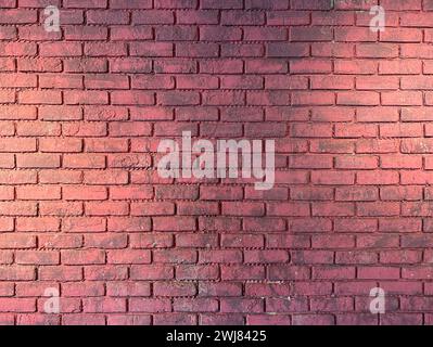 Red brick wall with track light illuminated background Stock Photo