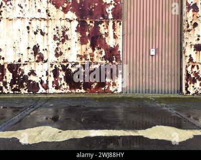 Peeling paint and rust on hangar doors Stock Photo