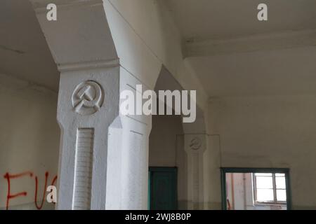 351 Hammer and sickle communist symbols engraved on the columns of an abandoned former primary school. Vevchani-North Macedonia. Stock Photo