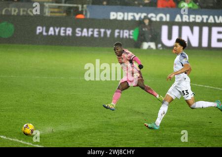 Swansea, UK. 13th Feb, 2024. Wilfried Gnonto of Leeds Utd shoots and scores his teams 4th goal . EFL Skybet championship match, Swansea city v Leeds Utd at the Swansea.com Stadium in Swansea, Wales on Tuesday 13th February 2024. this image may only be used for Editorial purposes. Editorial use only, pic by Andrew Orchard/Andrew Orchard sports photography/Alamy Live news Credit: Andrew Orchard sports photography/Alamy Live News Stock Photo