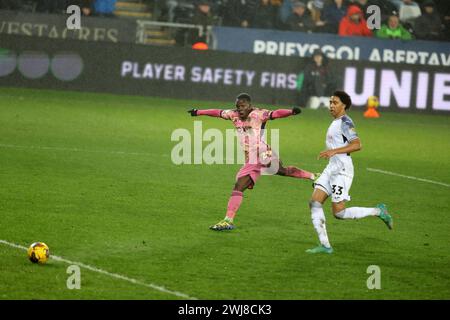 Swansea, UK. 13th Feb, 2024. Wilfried Gnonto of Leeds Utd shoots and scores his teams 4th goal . EFL Skybet championship match, Swansea city v Leeds Utd at the Swansea.com Stadium in Swansea, Wales on Tuesday 13th February 2024. this image may only be used for Editorial purposes. Editorial use only, pic by Andrew Orchard/Andrew Orchard sports photography/Alamy Live news Credit: Andrew Orchard sports photography/Alamy Live News Stock Photo