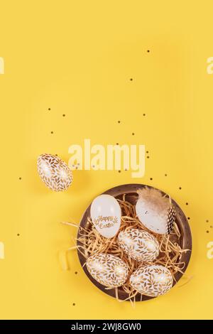 Table place setting and festive easter decor on yellow background Stock Photo