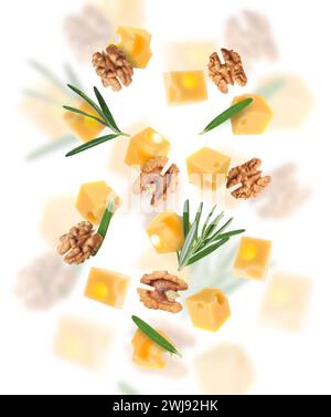 Cheese, walnuts and rosemary flying on white background Stock Photo