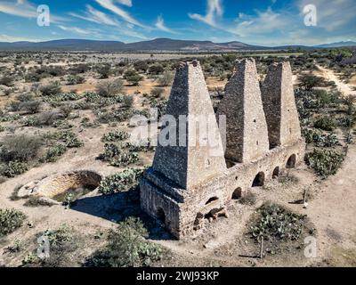 Drone capture of the enduring colonial mining ovens in Mineral de Pozos, Guanajuato, set against the backdrop of the arid Mexican landscape. Stock Photo