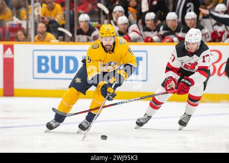 Bridgestone Arena. 13th Feb, 2024. Tennessee, USA; Nashville Predators left wing Filip Forsberg (9) skates as New Jersey Devils defenseman Simon Nemec (17) defends during the first period at Bridgestone Arena. Mandatory Credit: Steve Roberts-USA TODAY Sports. Credit: csm/Alamy Live News Stock Photo