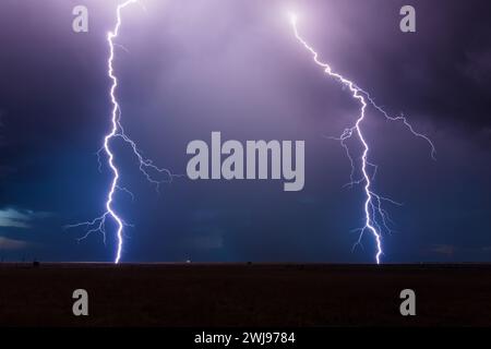 A pair of lightning strikes from a thunderstorm near House, New Mexico Stock Photo