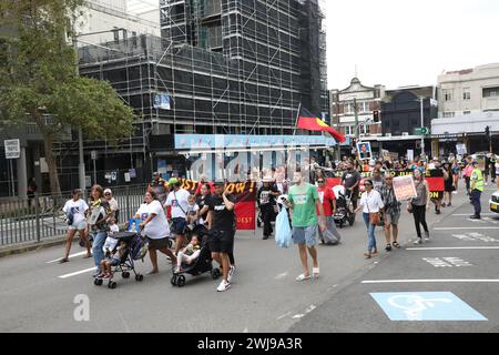 Sydney, Australia. 14 February 2024. Supporters assembled in Waterloo Green (TJ Hickey Park) in Waterloo on the twentieth anniversary of the death of Thomas ‘TJ’ Hickey. The death of the 17-year-old Aboriginal boy sparked the Redfern riots. Protesters blame the police for his death. They marched from Waterloo Green (TJ Hickey Park) next to the Waterloo public housing block where the incident happened to the Redfern police station and onto the Redfern Community Centre on Hugo Street. Credit: Richard Milnes/Alamy Live News Stock Photo