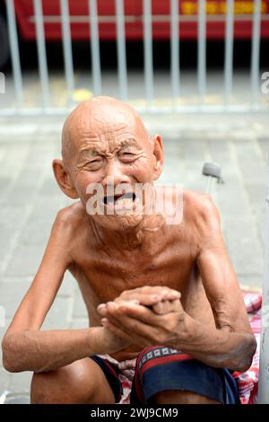 Portrait of a homeless old man crying for help. Stock Photo