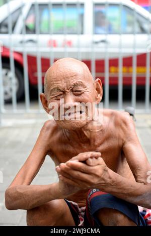 Portrait of a homeless old man crying for help. Stock Photo