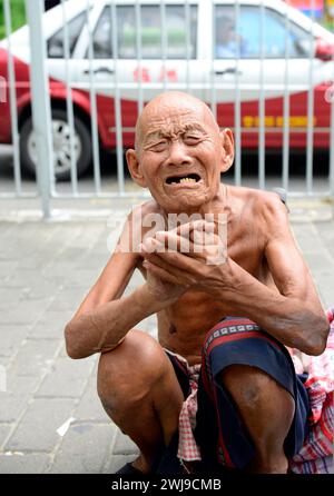 Portrait of a homeless old man crying for help. Stock Photo