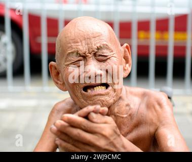 Portrait of a homeless old man crying for help. Stock Photo