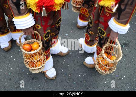 Binche, Belgium. 13th Feb, 2024. Oranges symbolizing good luck are pictured during the parade of Shrove Tuesday, the last day of Carnival, in Binche, Belgium, Feb. 13, 2024. Binche's three-day carnival, a UNESCO World Heritage event and one of the most famous carnivals in Europe, reached its climax on Tuesday. Credit: Zhao Dingzhe/Xinhua/Alamy Live News Stock Photo