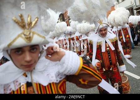 Binche, Belgium. 13th Feb, 2024. Local residents wearing costumes of 'Gille' attend the parade of Shrove Tuesday, the last day of Carnival, in Binche, Belgium, Feb. 13, 2024. Binche's three-day carnival, a UNESCO World Heritage event and one of the most famous carnivals in Europe, reached its climax on Tuesday. Credit: Zhao Dingzhe/Xinhua/Alamy Live News Stock Photo
