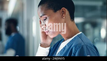 Doctor, stress and black woman with headache, anxiety or neck pain while working in a hospital at night. Healthcare, anxiety and female nurse with Stock Photo