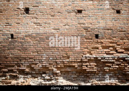 red brick, part of the ruins and ruined walls of medieval buildings , close up. Antique brickwork. The wall of the fort.vintage wall structure. old ru Stock Photo