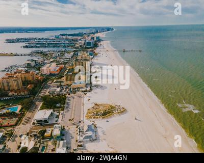 A scenic aerial perspective of Miami Beach showcasing the contrast between the bustling cityscape and the serene sandy coastline. Stock Photo
