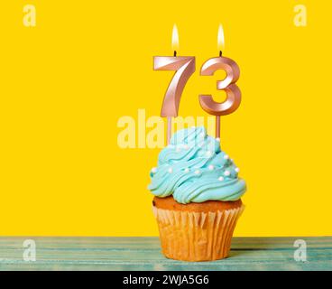 Birthday Cake With Candle Number 73 - On Yellow Background. Stock Photo