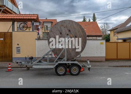 fiber optic cable reel on a roadside trailer Stock Photo