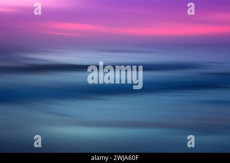 Abstract seascape with blurred motion, capturing the serene movement of the waves under a gradient sky of deep blues and vibrant pinks, reminiscent of Stock Photo