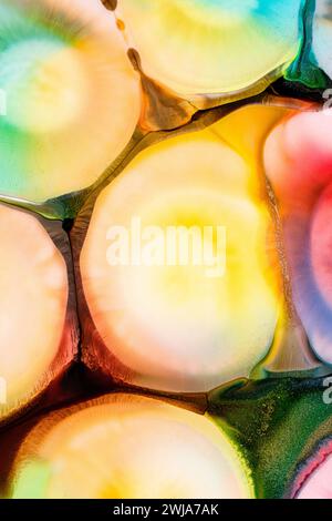 This image showcases a fluid abstract pattern with a blend of warm yellow, and green hues, creating a visually rich texture. Stock Photo