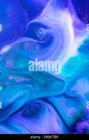 A striking abstract image featuring swirling patterns of blue and green, resembling a fluid or marble backdrop Stock Photo