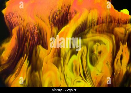 An abstract composition featuring warm oranges and yellows with fluid swirl patterns creating a dynamic and vibrant backdrop Stock Photo