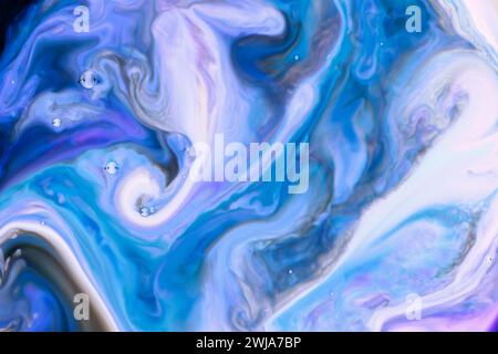 An abstract blend of blue and purple hues creates a marbled effect with intricate swirls and fluid motion in a high-resolution image Stock Photo