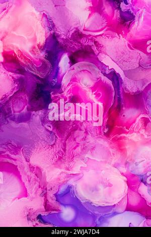 An abstract and dreamy fusion of pink and purple hues in a fluid art design, creating a mesmerizing marble effect perfect for creative backgrounds Stock Photo
