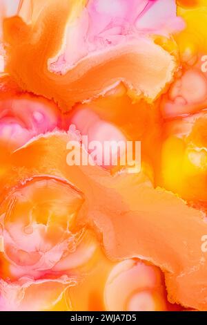 Vibrant abstract background with dynamic swirls of pink, orange, and yellow hues, mimicking fluid art Stock Photo