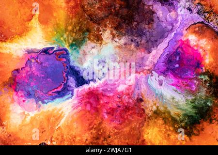 A colorful abstract with vivid ink patterns resembling fluid art, showcasing a mix of warm and cool tones blending organically Stock Photo