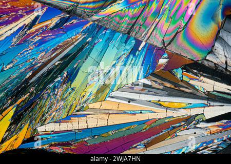 Vivid microscopic view of erythritol sugar crystals displaying a kaleidoscope of colors with angular shapes and patterns Stock Photo