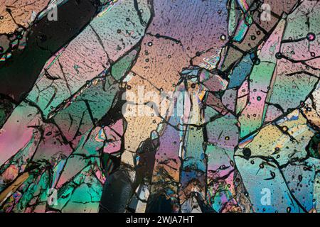 Polarized light microscopy creates a stained-glass effect in this detailed image of erythritol sugar crystals with vibrant colors Stock Photo