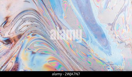 An abstract image showcasing the swirling colors and fluid patterns of a soap bubble under light Stock Photo