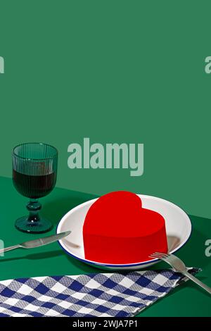 Image depicting a romantic Valentine's Day dinner setup with a heart-shaped decoration on a plate, elegant glassware, and cutlery. Stock Photo