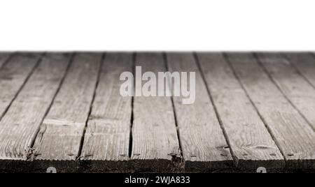 Empty wood table. Wood brown grey floor with empty white wall interior background. Stock Photo