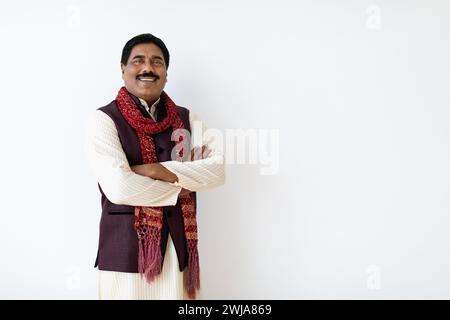 Confident mature indian man in national costume posing on white Stock Photo