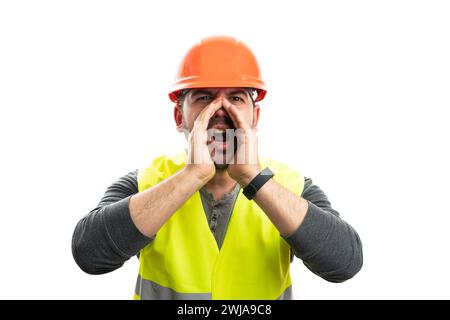 Adult male builder in work attire fluorescent yellow vest and safety helmet holding hands as shouting yelling gesture isolated on white studio backgro Stock Photo