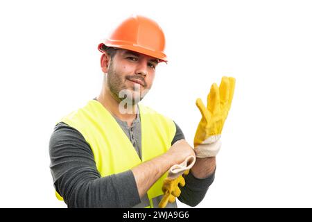 Adult constructor man with friendly trustworthy smile expression takin on work glove as getting ready concept isolated on white studio background Stock Photo