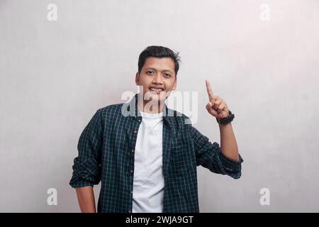 Mature man in plaid dress pointing at camera with one finger up isolated on white background Stock Photo