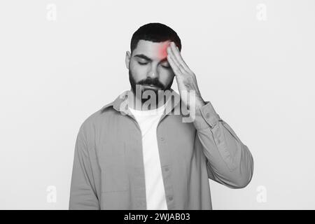 Unhappy young latin man with beard in casual put hand on forehead Stock Photo