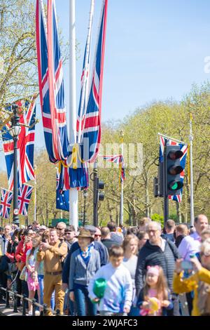 People take photographs near Buckingham Palace as London prepares for the coronation of King Charles III. Stock Photo