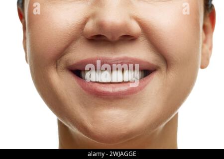 Cropped portrait of middle-aged woman with full moisturized pink lips and well-kept skin. Model smiling with teeth. Prevention of nasolabial folds. Stock Photo